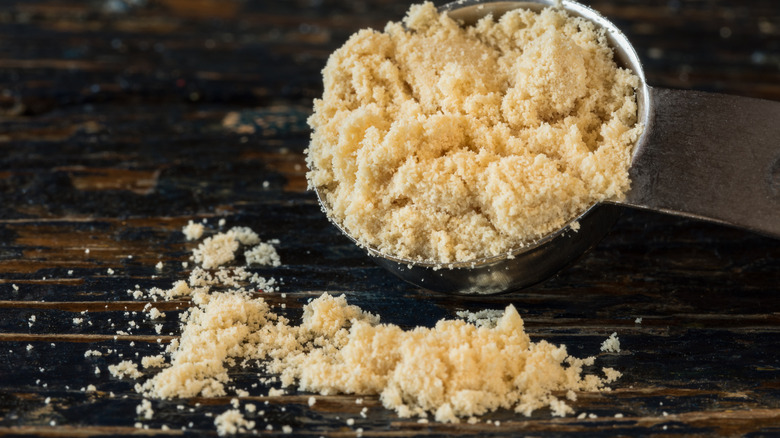 A small pile of malted milk powder on a measuring spoon