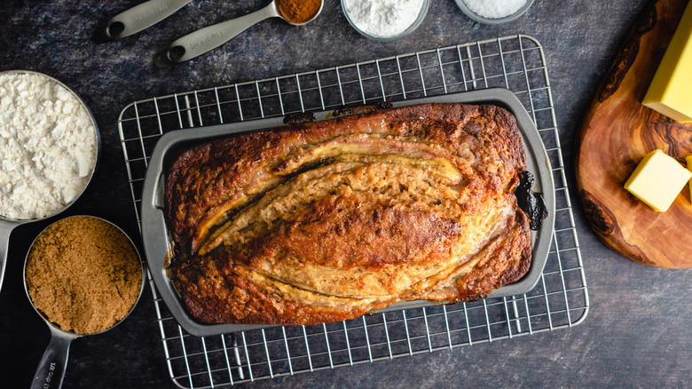 Top view of banana bread in a pan on a cooling rack