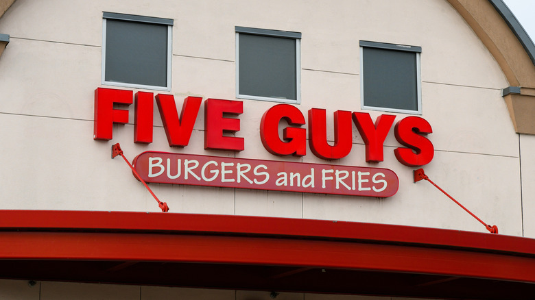 The exterior of a Five Guys location with red 