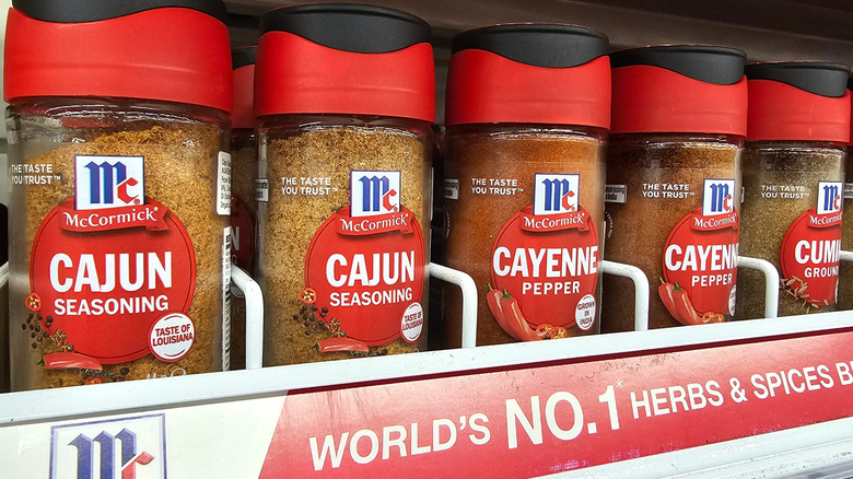 McCormick Cajun seasoning and Cayenne Pepper on a grocery store spice shelf