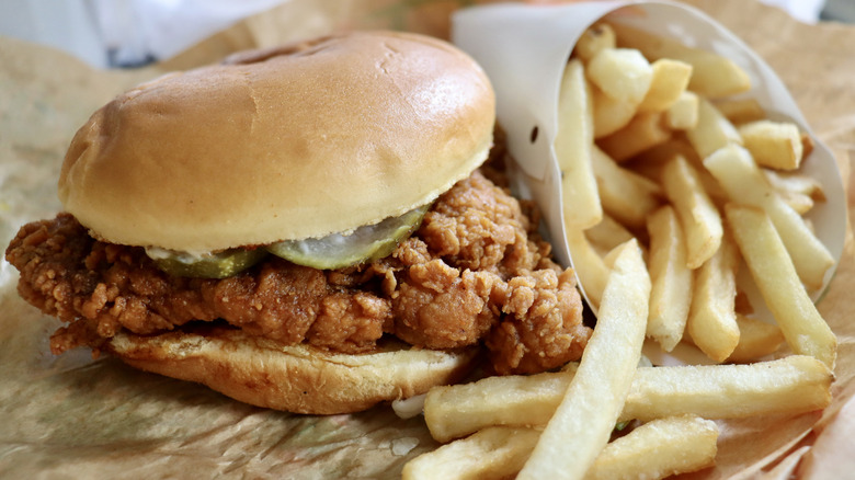 A fried chicken sandwich with fries