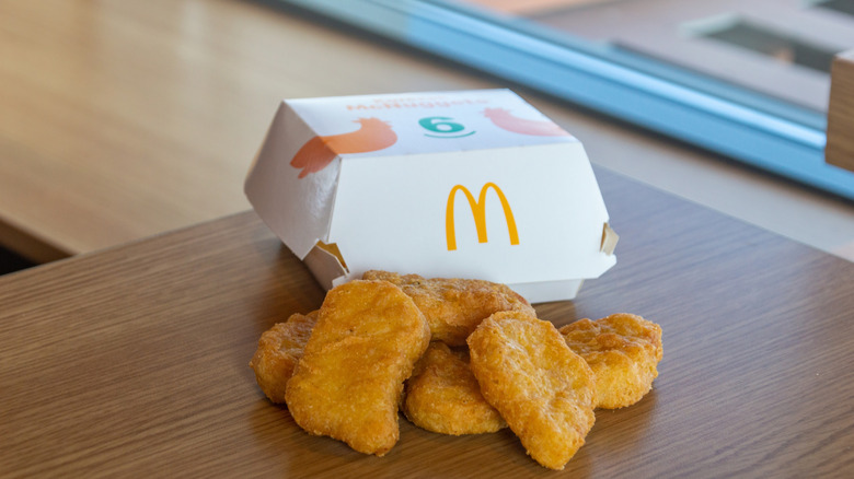 McNuggets sitting on a table in front of a box.