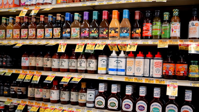 Grocery store shelves stocked with different sauces and dressings