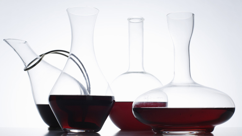 Different decanters with different red wines