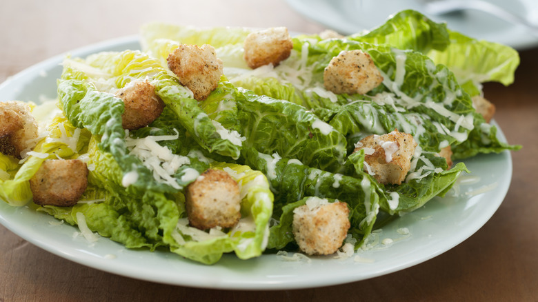 Whole leaves of romaine lettuce in a Caesar salad