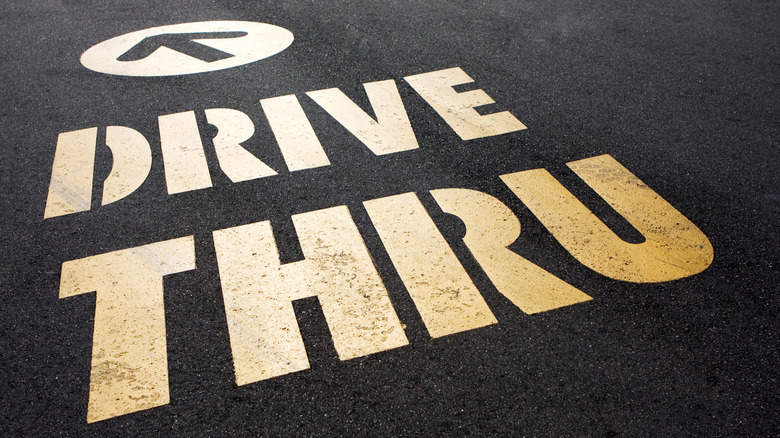 Image of drive-thru sign and arrow painted on pavement