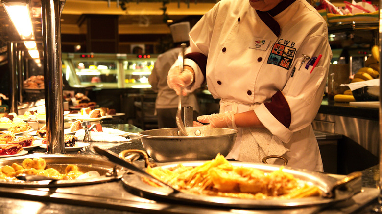 A chef working at a buffet.