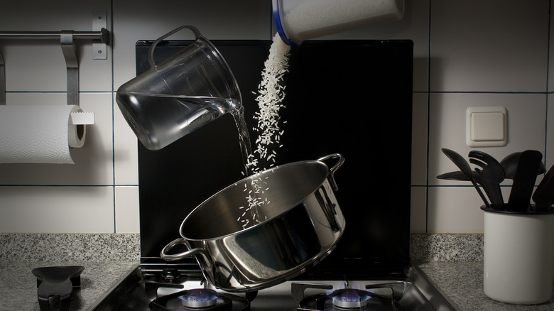 rice and water falling into a pot on the stove