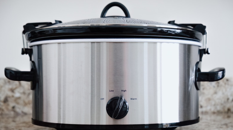 A slow cooker with condensation on the lid