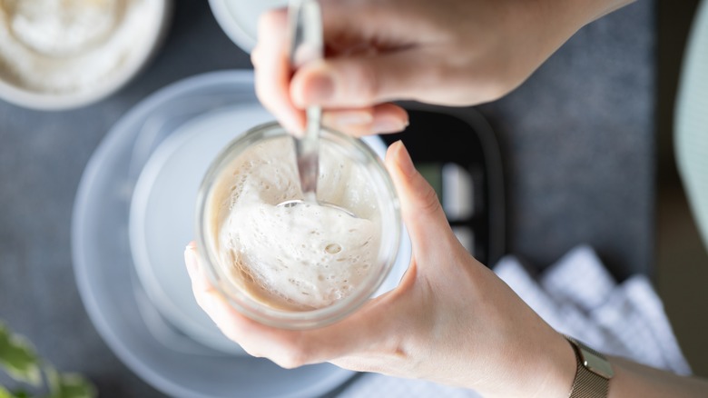 Woman mixing sourdough starter