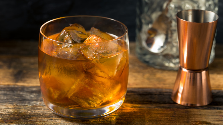 A French Connection cocktail over ice in a rounded rocks glass with a measure beside it