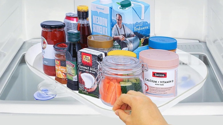 lazy susan in fridge with food and condiments