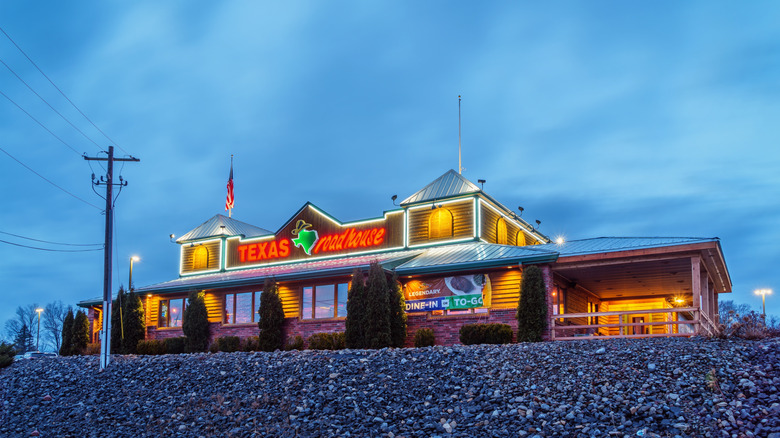 Exterior view of a Texas Roadhouse restaurant against a dusk sky