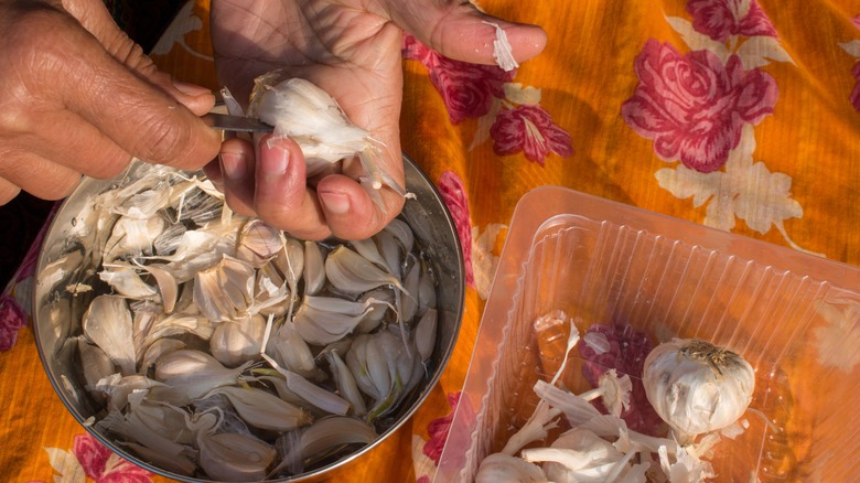 hands peeling garlic 