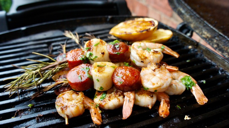 Shrimp and veggies skewered on rosemary on a grill