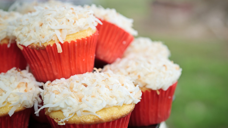 Cupcakes with coconut frosting in red cases