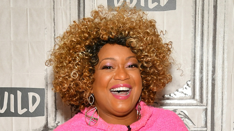 Sunny Anderson smiling on a red carpet