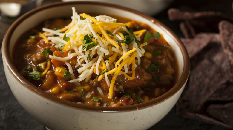 A bowl of Southwestern chili with shredded cheese on top