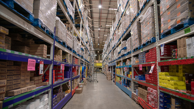 An aisle full of merchandise at a warehouse grocery store.