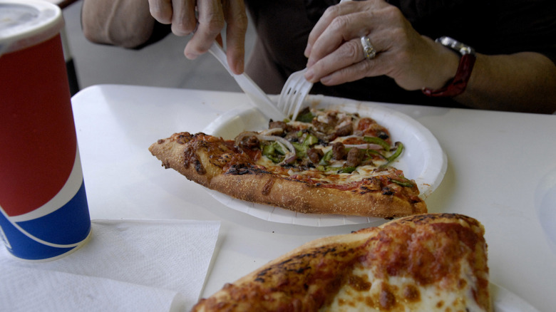 A person eating Costco pizza