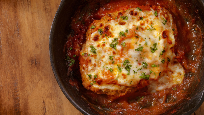 A serving of chicken parmesan in a skillet