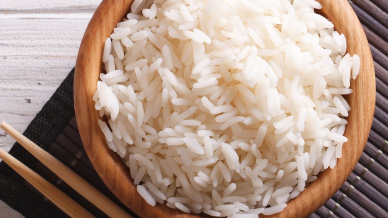 rice in bowl with chopsticks