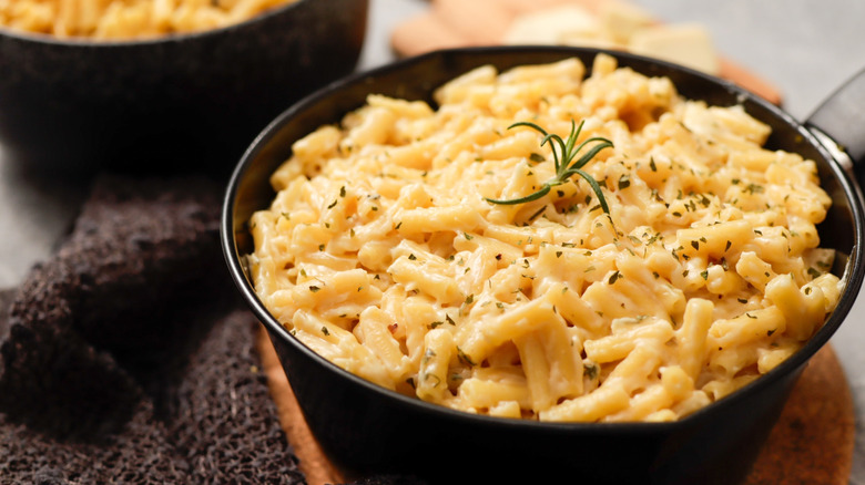 A creamy mac and cheese pasta dish in a black pot