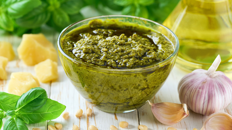 Small glass bowl of pesto with parmesan, basil, olive oil, garlic, and pine nuts