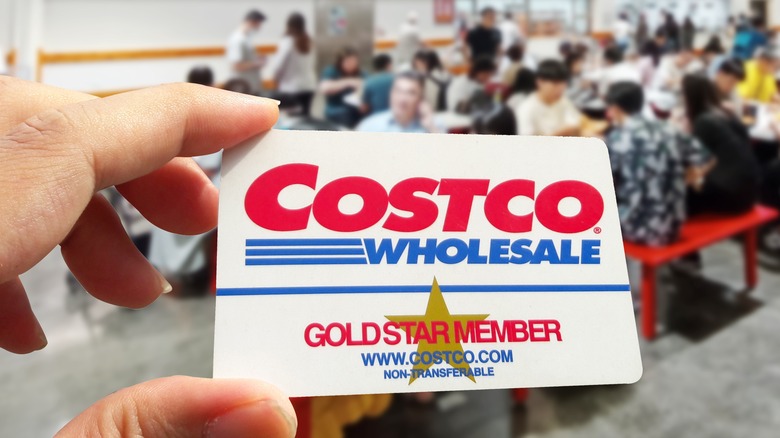 Hand holding a Costco card