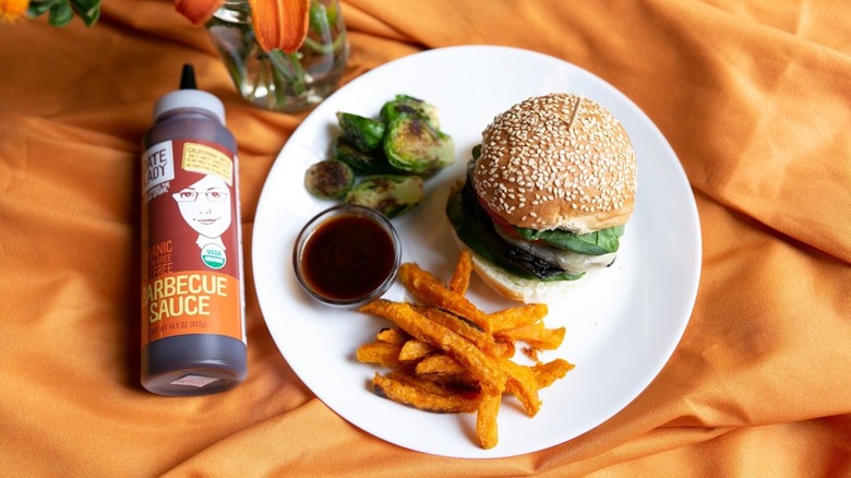 Date Lady barbecue sauce bottle next to a burger