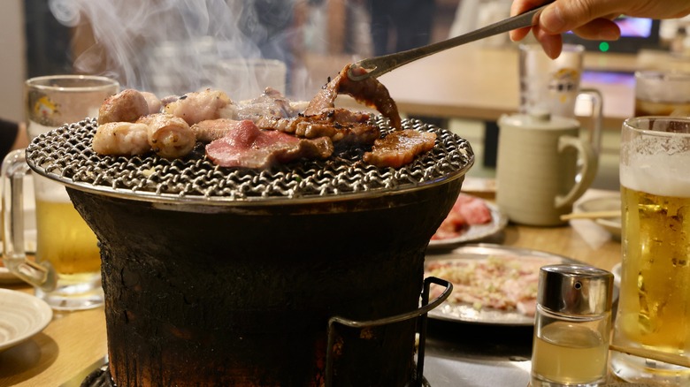 Meat cooking on a small barbecue grill