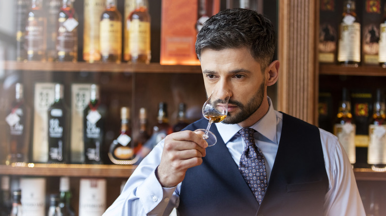 Well-dressed man, whiskey tasting