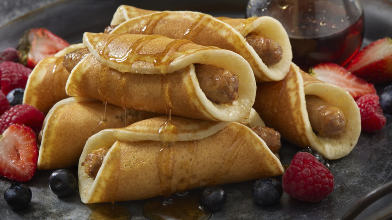 Breakfast pigs in a blanket using sausage and pancakes with syrup