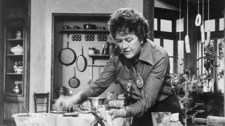 Julia Child making sausages in a kitchen