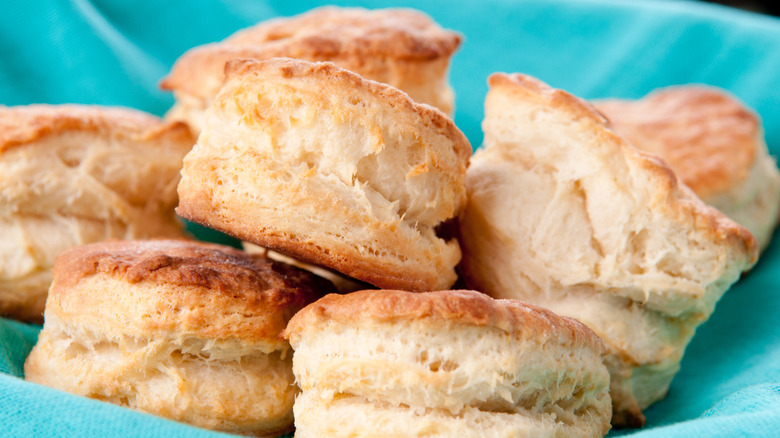 Buttermilk biscuits in a basket lined with blue cloth