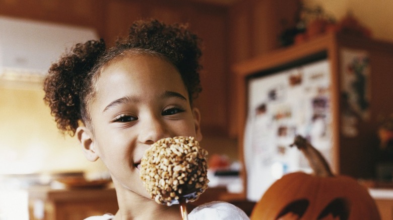 girl eating caramel apple