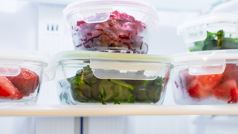 fruits and veggies in glass containers in fridge