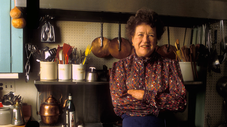 Julia Child posing for a portrait in her kitchen