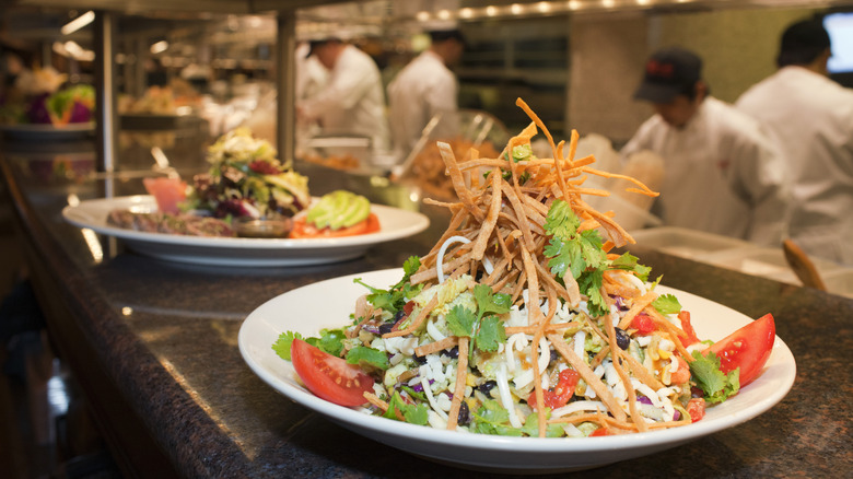 A plate of food from The Cheesecake Factory sitting on a counter.