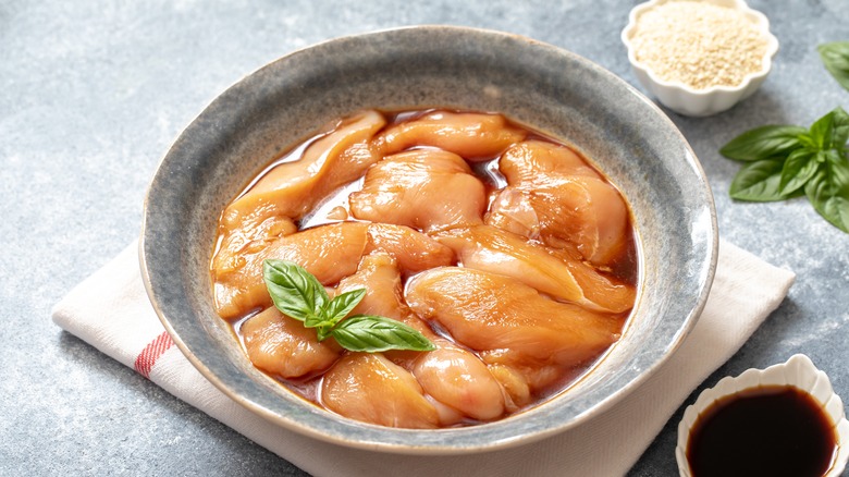 a bowl of chicken marinating