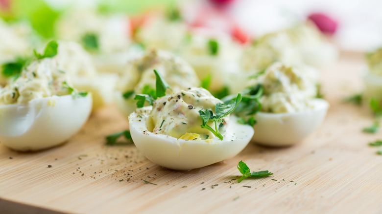 deviled eggs with green garnishes