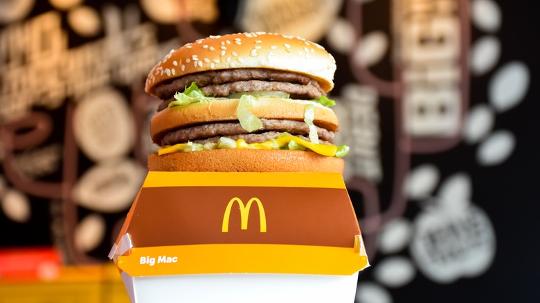 A Big Mac sitting on top of a McDonald's Big Mac container