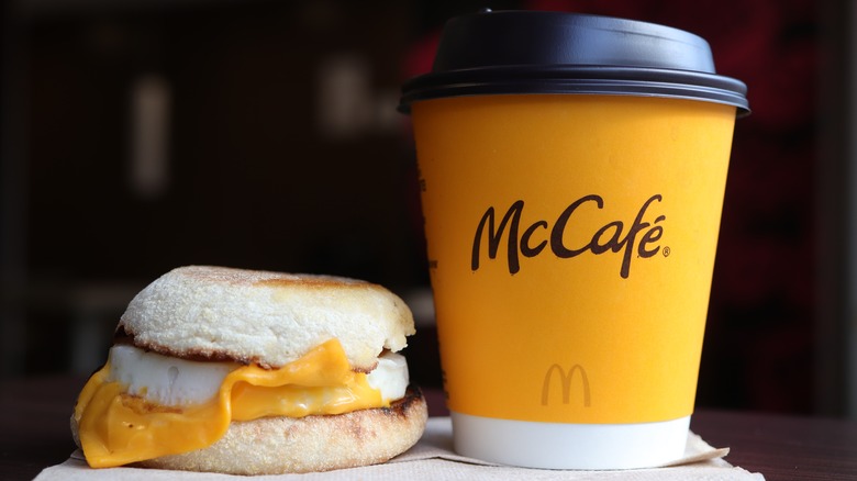 A McDonald's coffee cup beside an egg McMuffin