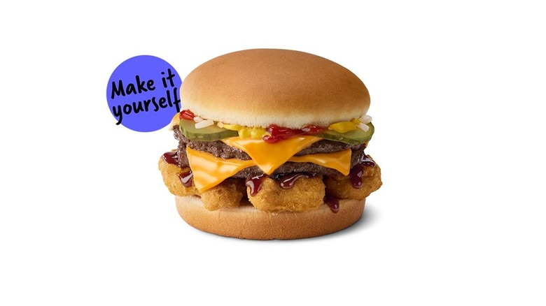 A Crunchy Double (McDouble with Chicken Nuggets and BBQ sauce on it) with the words "make it yourself" near it on a white background.