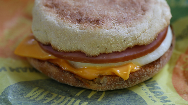 A close up of an Egg McMuffin on a McDonald's food wrapper.