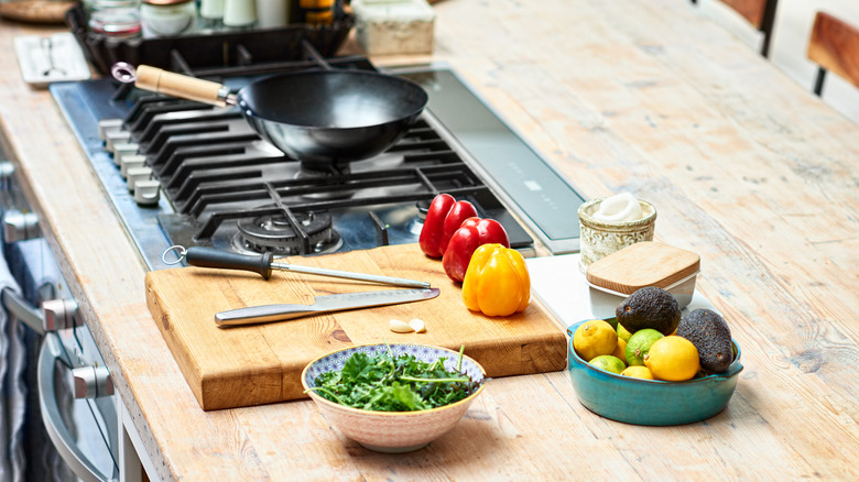 A cook's workstation with ingredients and wok