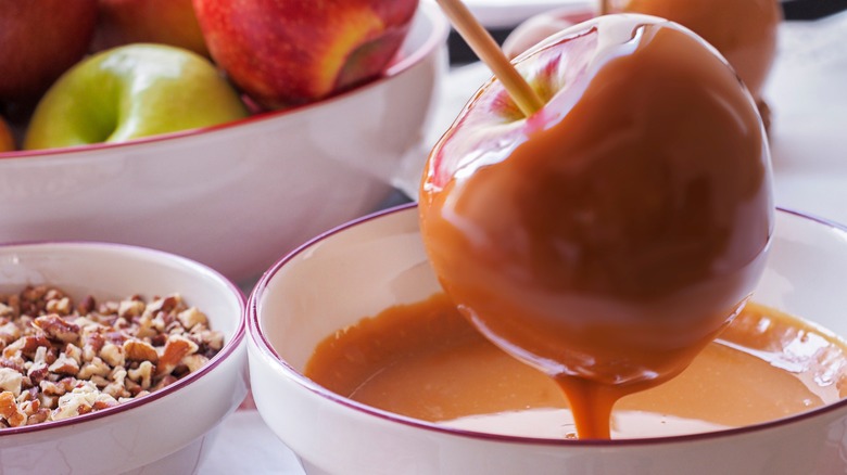 dipping apples into caramel