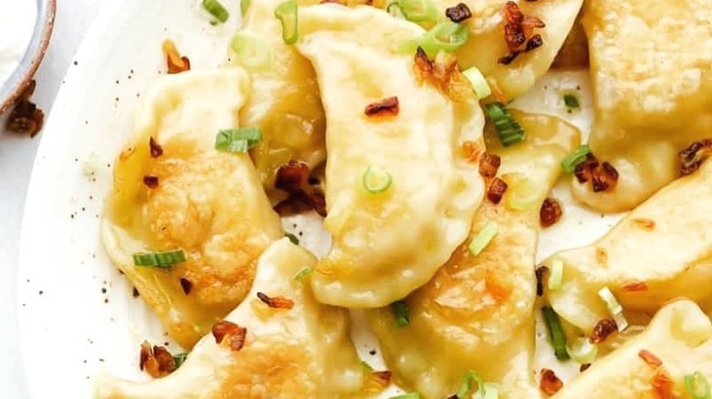 A close-up of pierogies on a plate.