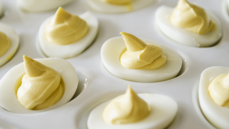 A white tray full of deviled eggs