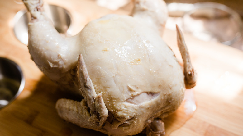 A whole cooked chicken on a cutting board